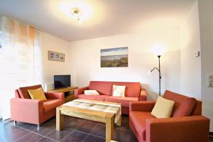 a living room with two couches and a coffee table at Störtebeker in Norddeich