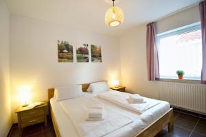 a bedroom with two beds and a window at Störtebeker in Norddeich