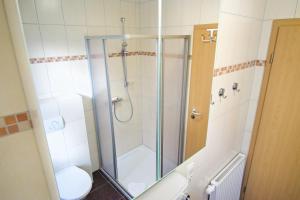 a bathroom with a shower and a toilet at Störtebeker in Norddeich +15 photos