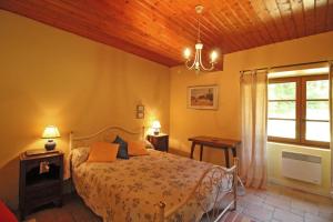 a bedroom with a bed and a window and a chandelier at Beaufort in Blond