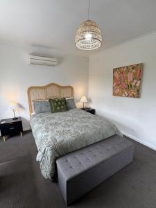 a bedroom with a large bed and a pendant light at Teringie Retreat with Breathtaking Views in Norton Summit +43 photos