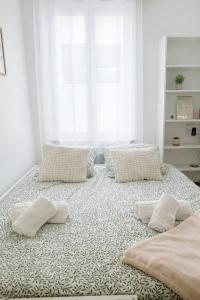 a large bed with pillows on it in a room at Studio Rive Royale in Viroflay +10 photos