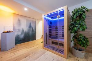 a room with a glass door with a plant in it at MyWinkl Design-Ferienwohnungen in Reit im Winkl +133 photos