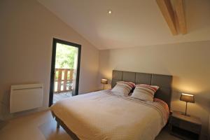 a bedroom with a large bed with two pillows at Trois ânes et un moulin in Bessines-sur-Gartempe