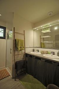 a bathroom with two sinks and a mirror at Trois ânes et un moulin in Bessines-sur-Gartempe +47 photos
