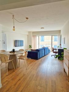 a living room with a blue couch and a table at Fully equiped 100 m2 appt with the perfect location in Vilvoorde
