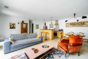 a living room with a couch and a table at Maison Jeannot - Climatisée avec piscine in Vers Pont du Gard +10 photos