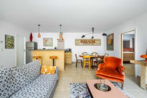 a living room with a couch and a table at Maison Jeannot - Climatisée avec piscine in Vers Pont du Gard