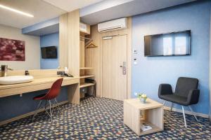 a hospital room with a desk and two chairs at Kongres Hotel Roca in Košice