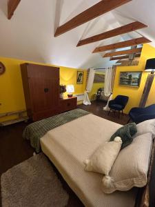 a bedroom with two beds with yellow walls at Brīdis Sev in Ķekava