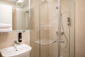 a bathroom with a shower and a sink at Homaris Nolli Studios in Berlin +25 photos