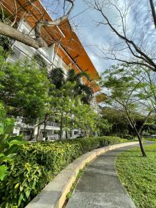 a walking path in front of a building at Beach condos at Pico de Loro Cove & possible Beach Club Access & Wi-Fi & Netflix, 42-50''TVs with Uratex beds & pillows, equipped kitchen, balcony, parking, guest registration fee is not included in Nasugbu