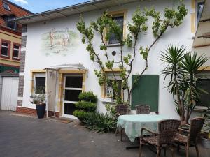 a table and chairs in front of a building at Ferienhaus ODIN in Großräschen