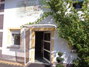 a building with a door and a painting on the wall at Ferienhaus ODIN in Großräschen