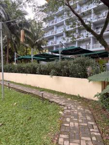 a brick path in front of a building at Beach condos at Pico de Loro Cove & possible Beach Club Access & Wi-Fi & Netflix, 42-50''TVs with Uratex beds & pillows, equipped kitchen, balcony, parking, guest registration fee is not included in Nasugbu