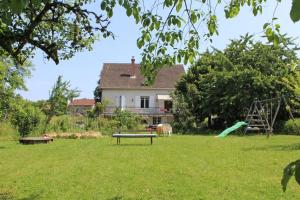 a park with a playground in front of a house at - les vieux fourneaux - in Nantiat