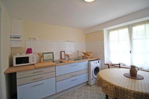 a kitchen with a sink and a washing machine at - les vieux fourneaux - in Nantiat +16 photos