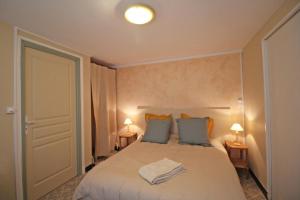 a bedroom with a large bed with two pillows at - les vieux fourneaux - in Nantiat