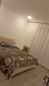 a bedroom with a bed and a curtain at Moy Dom in İsmayıllı +28 photos