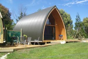 a round house with a metal roof on a yard at Wetland View Park in Anatori