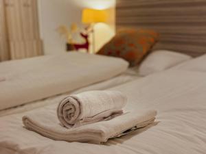 a towel on a bed in a hotel room at Alpinresort Kaprun 3 in Kaprun +32 photos