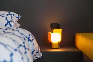 a lamp sitting on a table next to a bed at B&B Portorosso in Monopoli
