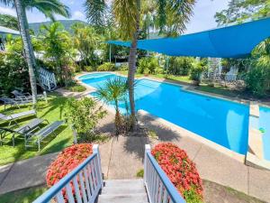 a view of the pool from the balcony of a resort at Coral Mango in Airlie Beach