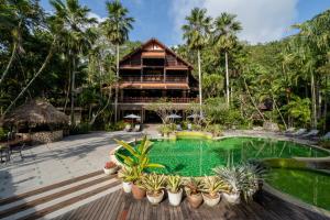 a resort with a pool and a building at River Kwai Resotel in Sai Yok