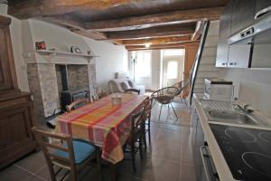 a kitchen and dining room with a table and chairs at Mémé jeanne in Ambazac