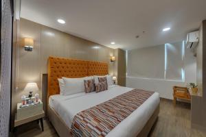 a bedroom with a large bed in a room at AR Suites Sohna Road in Gurgaon