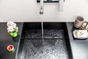 a kitchen sink with water running from a faucet at B&B Portorosso in Monopoli