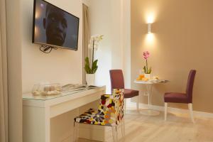 a living room with a tv hanging on a wall at B&B Mondello Design in Mondello
