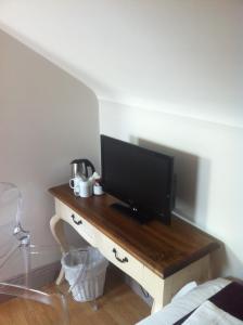 a television on a wooden table in a room at Abbey Lodge B&B in Galway
