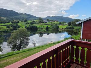 a view of a lake from a balcony at Vassel gård in Herand