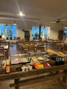 a cafeteria with a buffet of food on a table at Penzion WIESEN in Meziměstí
