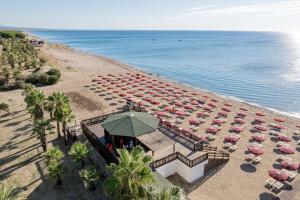 an overhead view of a beach with a bunch of umbrellas at Club Esse Sunbeach in Squillace
