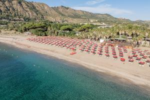 an aerial view of a beach with chairs and umbrellas at Club Esse Sunbeach in Squillace +85 photos