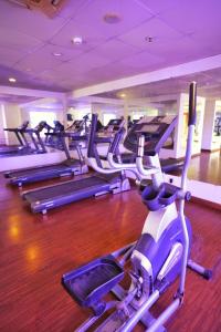 a gym with a row of treadmills at The Altruist Hitech Hotel in Hyderabad