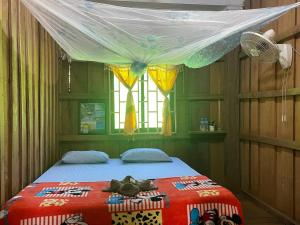 a bedroom with a bed with a canopy at កុយ ឡាយ-Koy Lay in Chi Phat