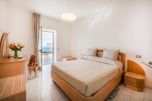a hotel room with a bed and a balcony at Hotel Il Pino in Praiano +96 photos