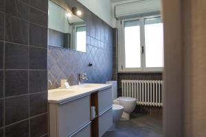 a bathroom with a sink and a toilet at B&B dolcenotte in Gattico +38 photos