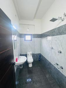 a bathroom with a toilet and a sink and a shower at Dubai Inn in Kanjirapalli +15 photos