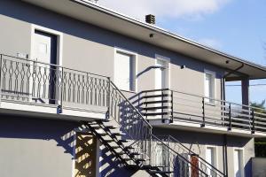 a house with a staircase on the side of it at B&B dolcenotte in Gattico