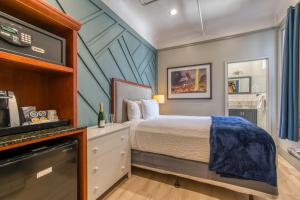 a bedroom with a bed and a tv at Ram's Hotel in San Francisco