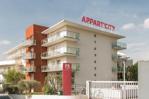 a apartment building with a sign on top of it at Appart'City Classic Antibes in Antibes