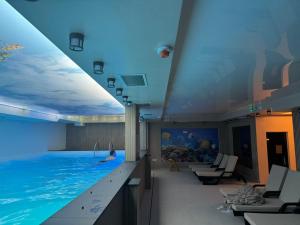a swimming pool in a hotel with a person swimming in it at Apartmani A in Kopaonik