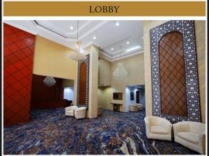 a lobby of a hotel with white chairs and a room at Maysan Al Mahbas Hotel in Al Khansāk +10 photos