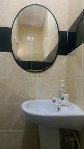 a bathroom with a sink and a mirror on the wall at Perfect Home in Lagos