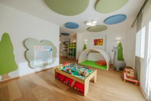 a childs play room with a table and toys at Hotel Babymio in Kirchdorf in Tirol
