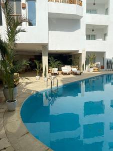 a swimming pool in front of a building at Blue Vision Diving Hotel in Marsa Alam City